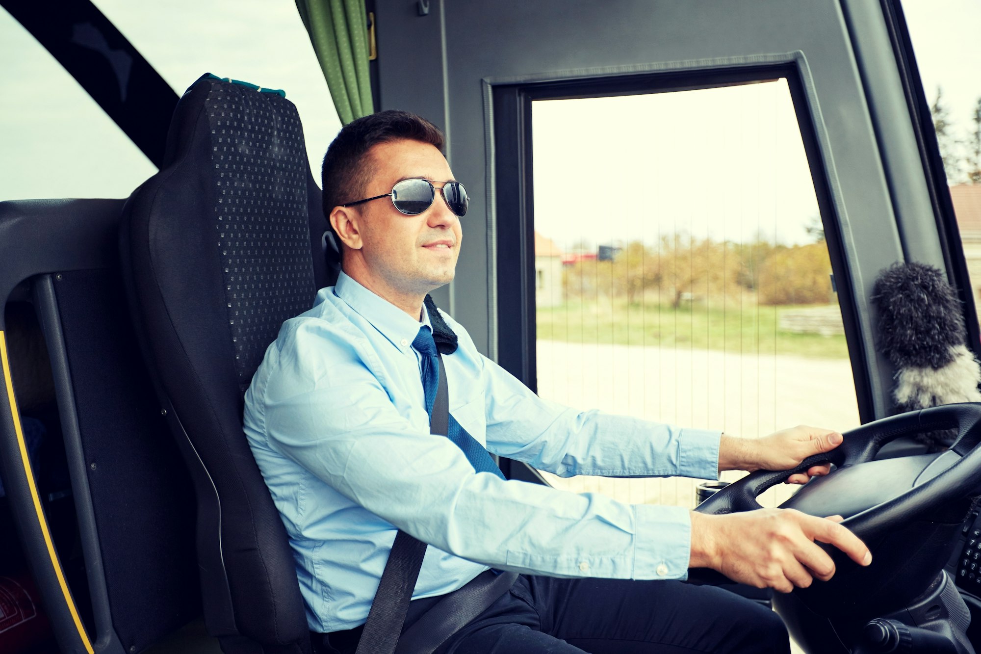 happy driver driving intercity bus ready to do his online cpc course